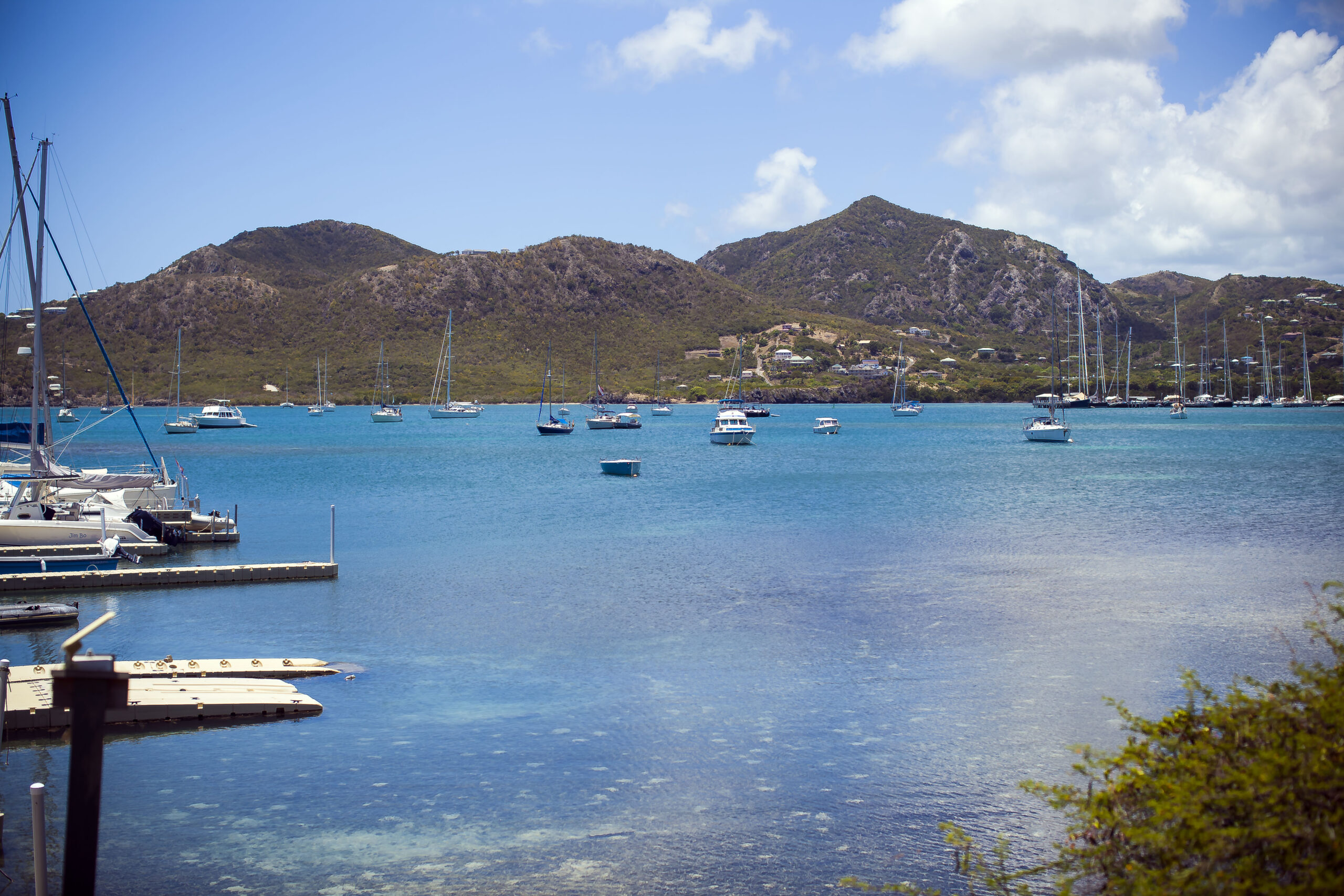 a small boat in a body of water with a mountain in the background