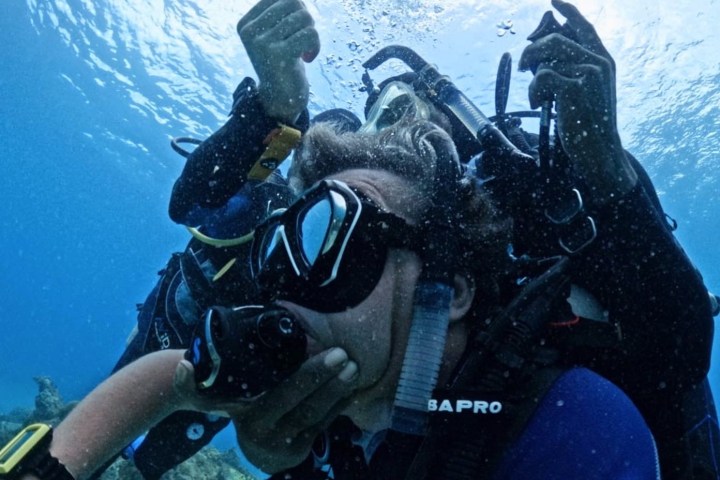 scuba divers practicing rescue techniques